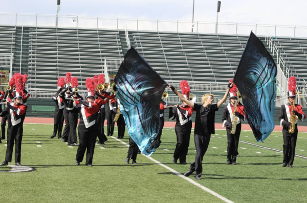 Color Guard section leader Robert Serrano takes the center of the field to show the beauty of “spreading his wings” as the ‘Black Swan’